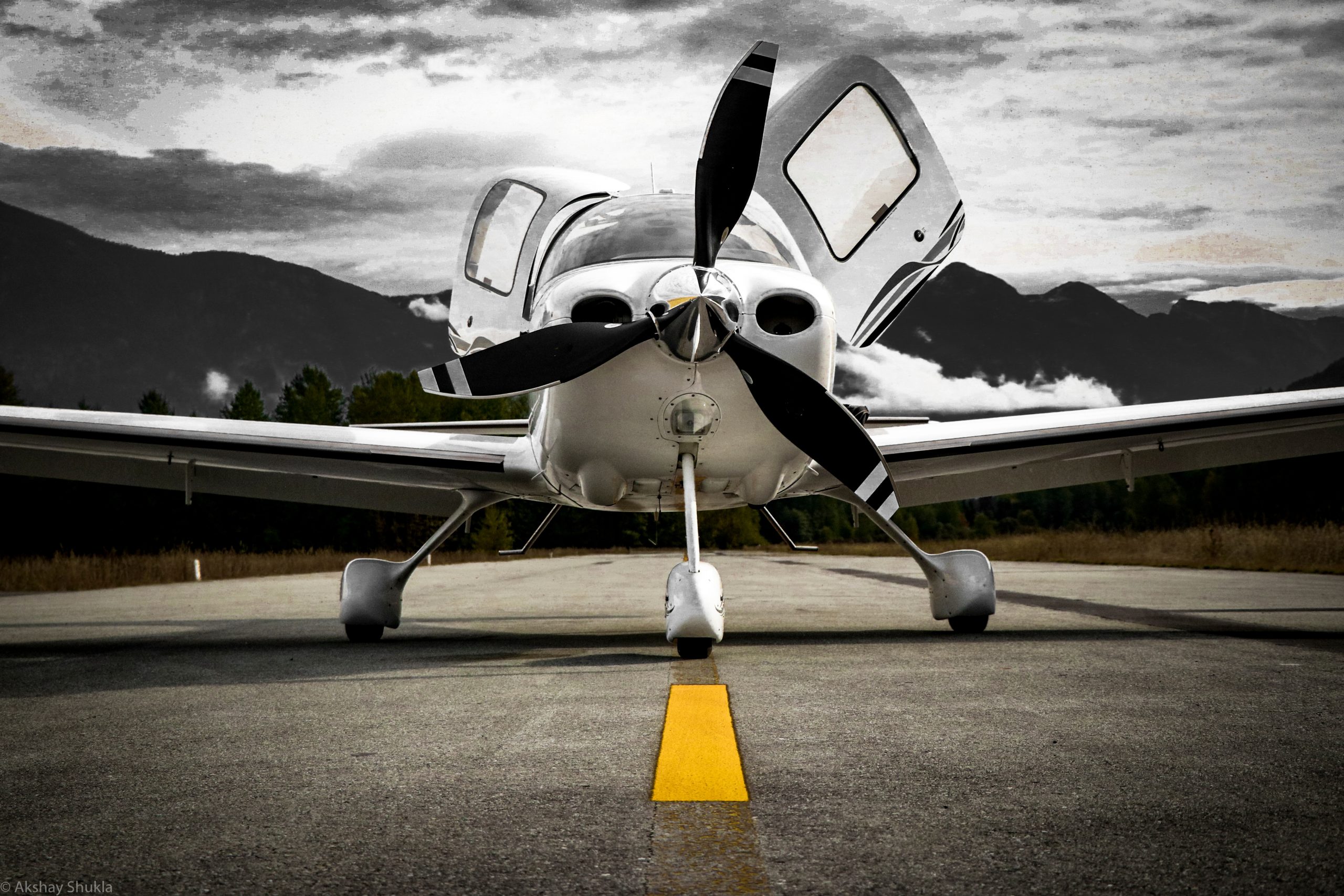 A high-performance piston aircraft on a dark, cinematic runway under a stormy mountain sky, symbolizing the 2026 economic "storm" and geopolitical volatility affecting the general aviation market.