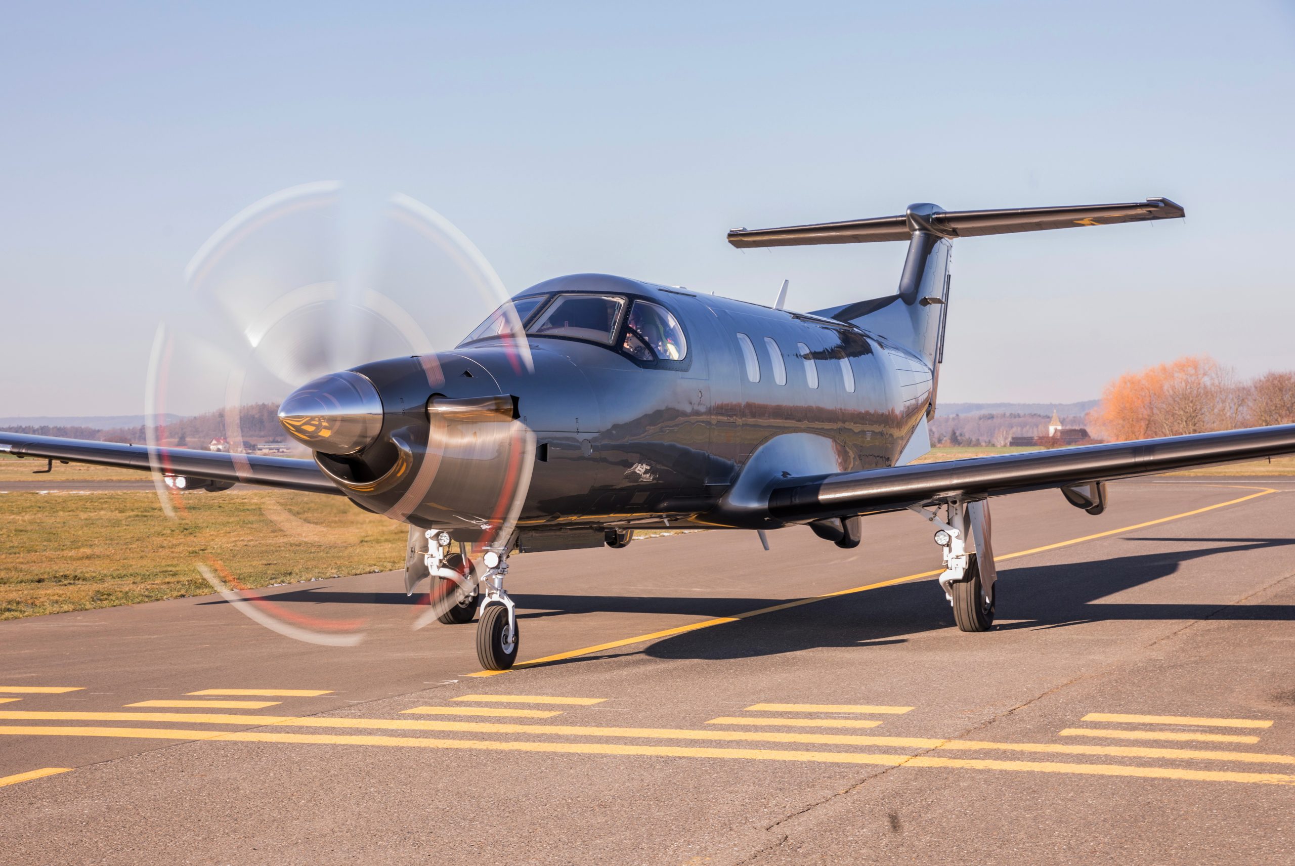 New single-engine turboprop taxiing on a sunny ramp