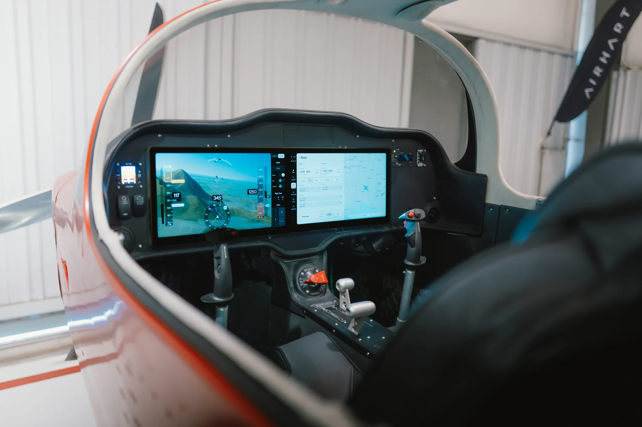 Airhart Avionics installed in the Airhart Sling — dual 14-inch touchscreen displays, Long Beach facility