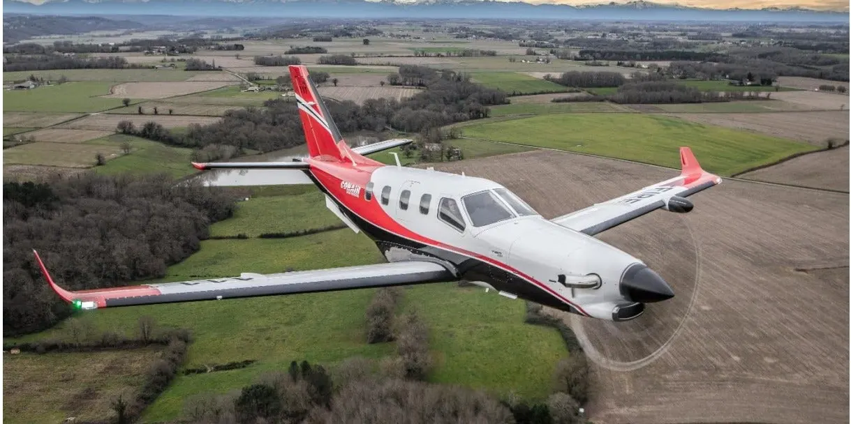 Daher TBM 960 in flight over the ocean at golden hour &mdash; turboprop financing by FLYING Finance