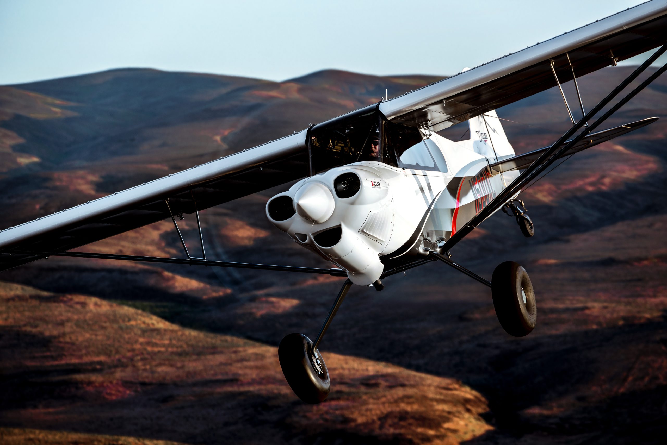 CubCrafters XCub low pass over tundra hills — certified backcountry taildragger