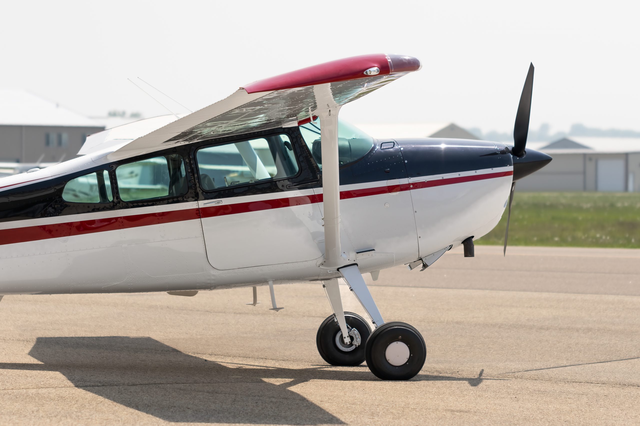 Classic high-wing Cessna single-engine utility aircraft on the ramp
